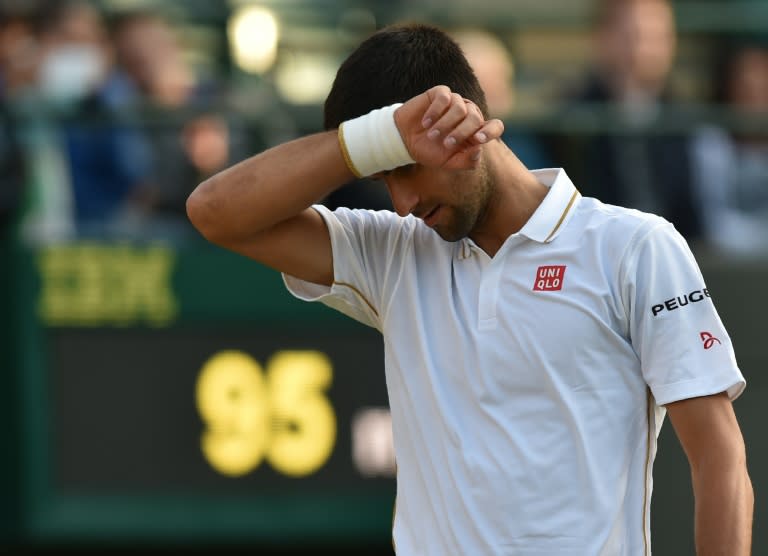 Serbia's Novak Djokovic reacts while playing US player Sam Querrey during their men's singles third round match at Wimbledon on July 1, 2016