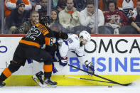 Philadelphia Flyers' Nicolas Aube-Kubel (62) and Tampa Bay Lightning's Nikita Kucherov (86) battle for the puck during the first period of an NHL hockey game, Saturday, Jan. 11, 2020, in Philadelphia. (AP Photo/Matt Slocum)