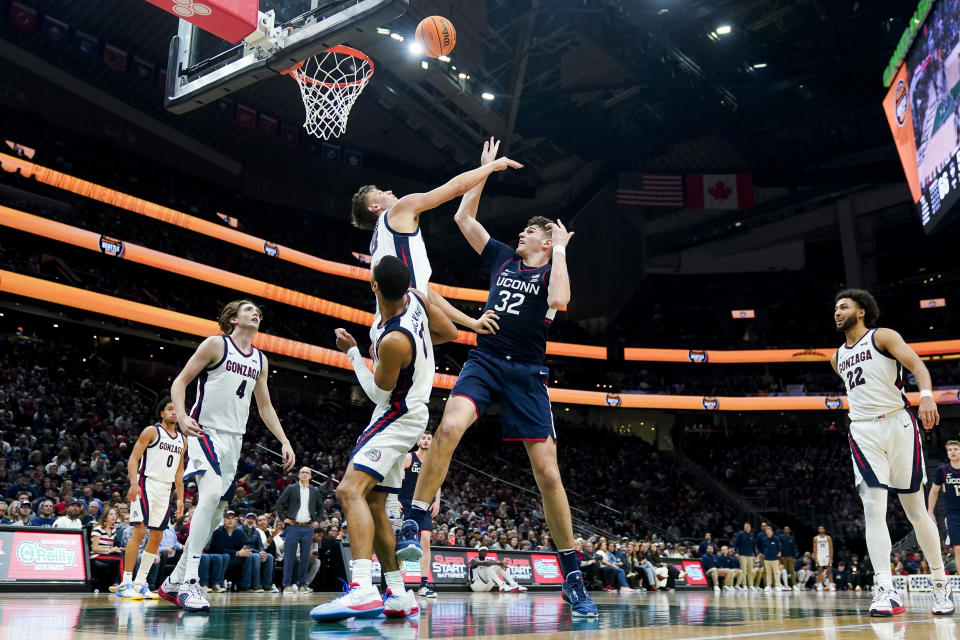 UConn center Donovan Clingan (32) shoots against Gonzaga forward Ben Gregg, top left, during the second half of an NCAA college basketball game Friday, Dec. 15, 2023, in Seattle. (AP Photo/Lindsey Wasson)
