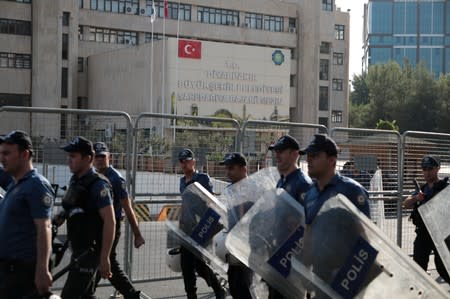 Turkish police walk in front of the Metropolitan Municipality headquarters in Diyarbakir