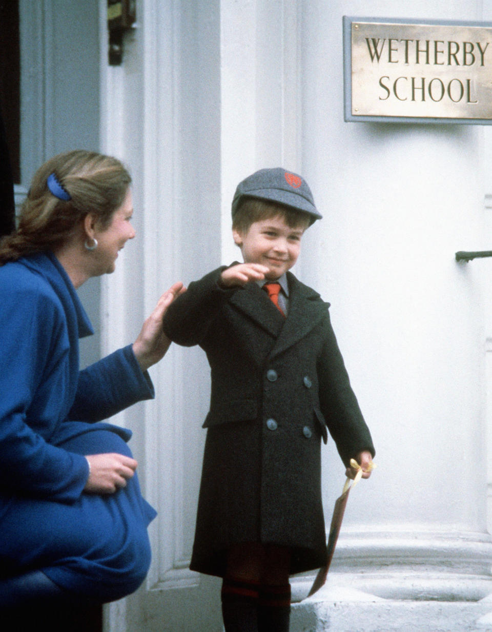 Prince William waves at onlookers after his first day at Wetherby School in Notting Hill Gate, London, in 1987. [Photo: PA]