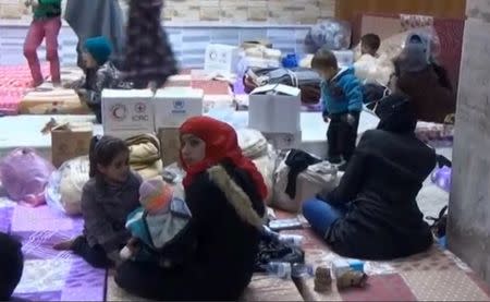 A still image taken from a video obtained by Reuters, said to be shot on January 4, 2017, shows civilians, who were evacuated from Wadi Barada, sitting inside a shelter in the Damascus suburb of Rawda, Syria. REUTERS TV/via REUTERS