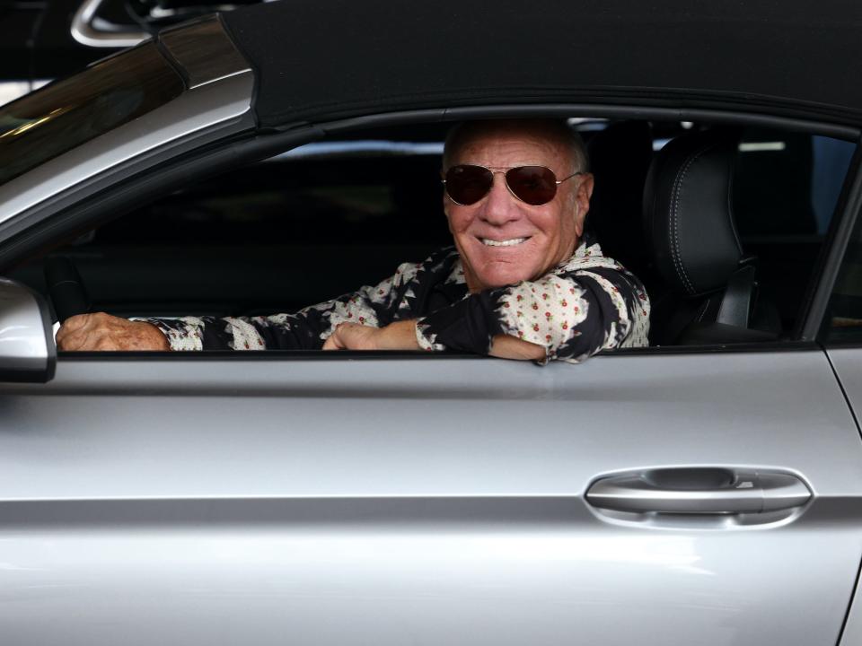 Barry Diller behind the wheel of a car smiling