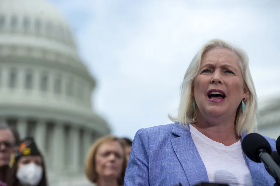 Sen. Kirsten Gillibrand addresses a press conference, with the Capitol in the background.