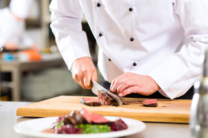 A chef cutting meat