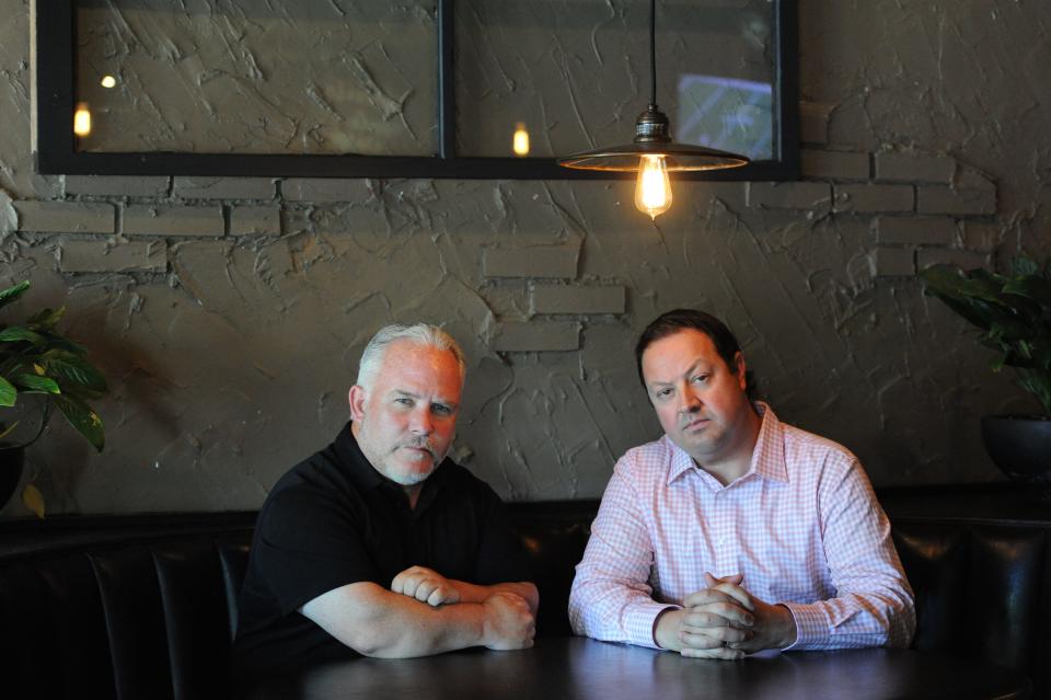 Casey Sherman, left, and Dave Wedge talk about their book, "Hunting Whitey." They were photographed at Tap City Grille where they would sometimes meet and talk about the book.