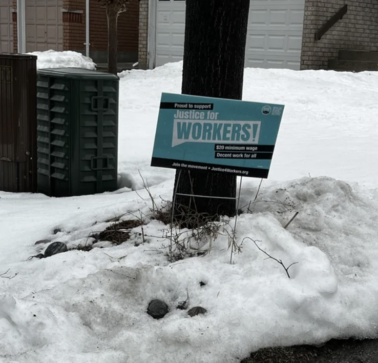 A "Justice for Workers!" sign on someone's lawn