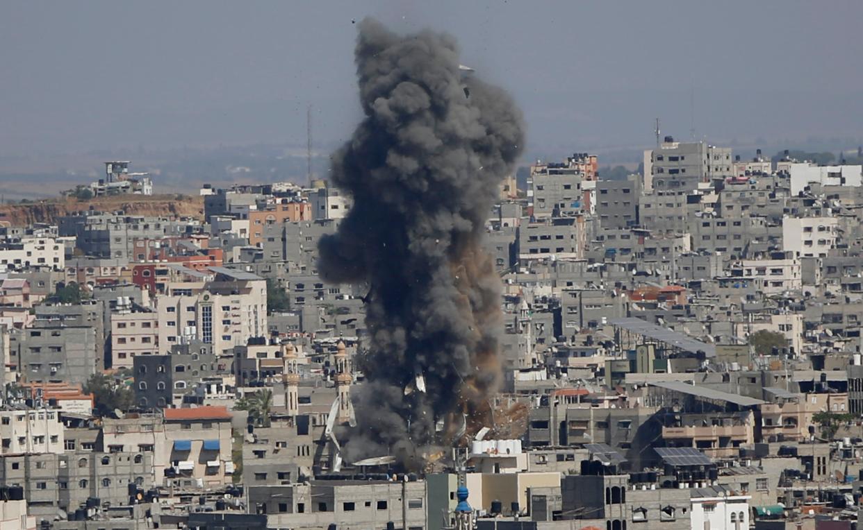Smoke rises following Israeli airstrikes on a building in Gaza City on Thursday, May 13, 2021.
