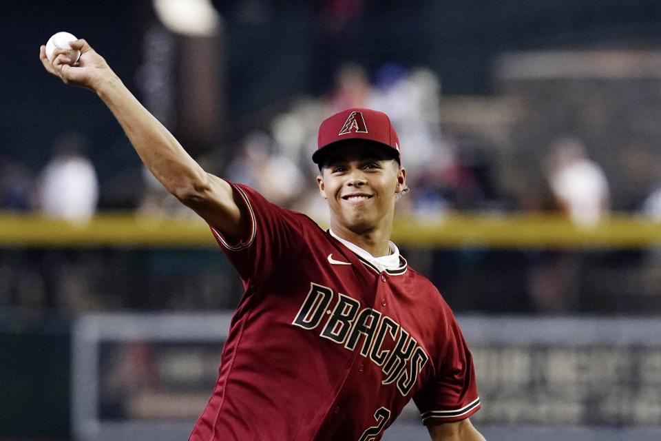 Arizona Diamondbacks' first-round draft pick Druw Jones throws out the first pitch prior to the team's baseball game against the Washington Nationals on Saturday, July 23, 2022, in Phoenix. (AP Photo/Ross D. Franklin)