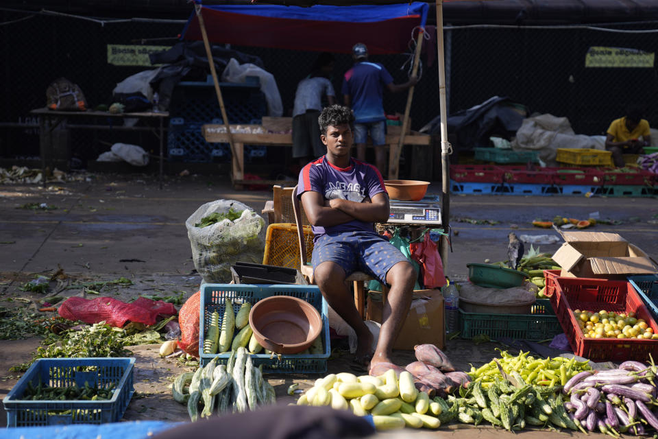 Vendors wait for customers at a vegetable market in Colombo, Sri Lanka, Wednesday, Dec. 13, 2023. The International Monetary Fund executive board has approved the release of $ 337 million second tranche of a bailout package to help Sri Lanka recover from its worst economic crisis. (AP Photo/Eranga Jayawardena)