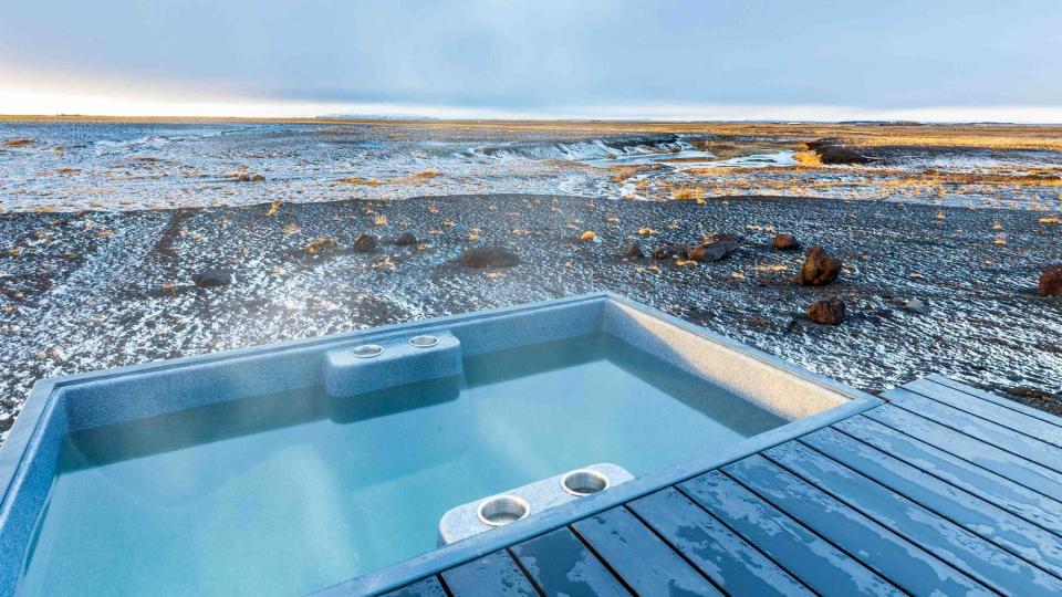 Glass house in Hella, Iceland, vast landscape views and nighttime view of Northern Lights