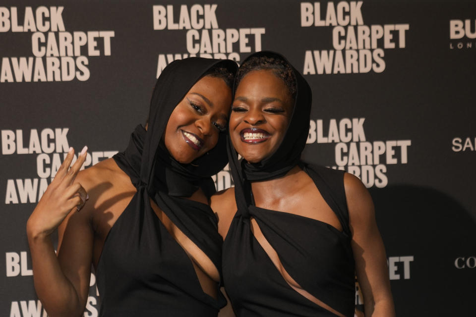 Paola and Pamela Ameyibor, better known as Polly & Pamy attend the first edition of the 'Black carpet awards', in Milan, Italy, Friday, Feb. 24, 2023. The founder of the Afro Fashion Association in Italy on Thursday said she is launching awards recognizing the achievements of minorities in Italian society, to promote greater diversity and inclusion. (AP Photo/Luca Bruno)