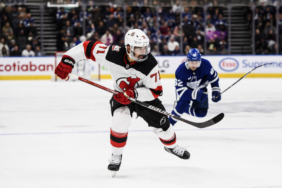 New Jersey Devils defenseman Jonas Siegenthaler (71) is pursued by Toronto Maple Leafs center Denis Malgin (62) during the second period of an NHL hockey game Thursday, Nov. 17, 2022, in Toronto. (Christopher Katsarov/The Canadian Press via AP)