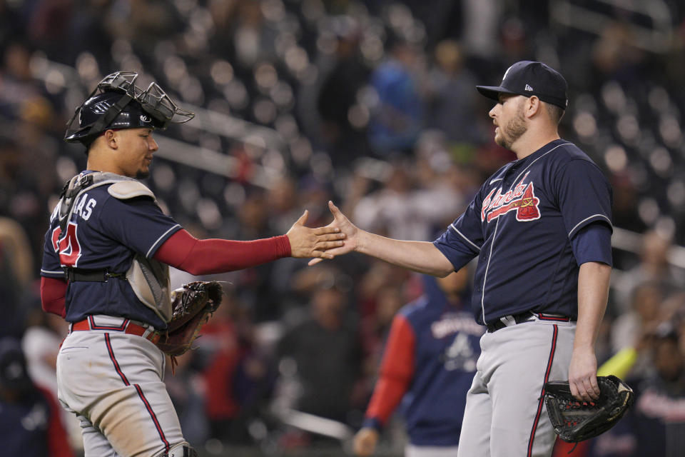 Atlanta Braves catcher William Contreras celebrates with relief pitcher Tyler Matzek after a baseball game against the Washington Nationals at Nationals Park, Tuesday, Sept. 27, 2022, in Washington. The Braves won 8-2. (AP Photo/Jess Rapfogel)