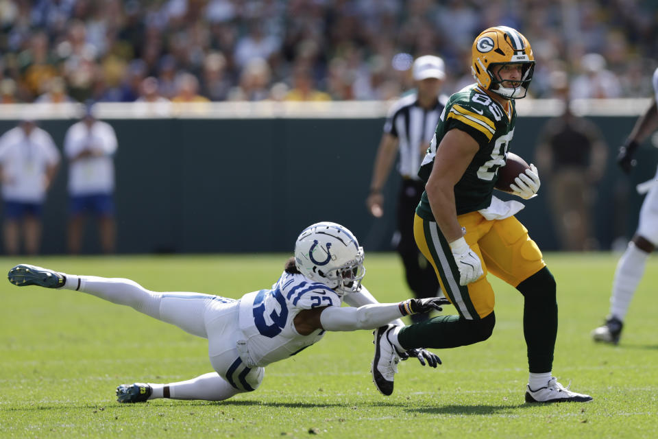 Green Bay Packers tight end Tucker Kraft (85) tries to escape from Indianapolis Colts cornerback Kenny Moore II (23) after making a catch during the second half of an NFL football game Sunday, Sept. 15, 2024, in Green Bay, Wis. (AP Photo/Matt Ludtke)