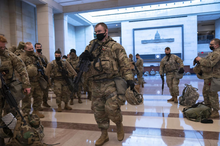 Hundreds of National Guard troops hold inside the Capitol Visitor's Center to reinforce security at the Capitol in Washington, Wednesday, Jan. 13, 2021. The House of Representatives is pursuing an article of impeachment against President Donald Trump for his role in inciting an angry mob to storm the Capitol last week. (AP Photo/J. Scott Applewhite)