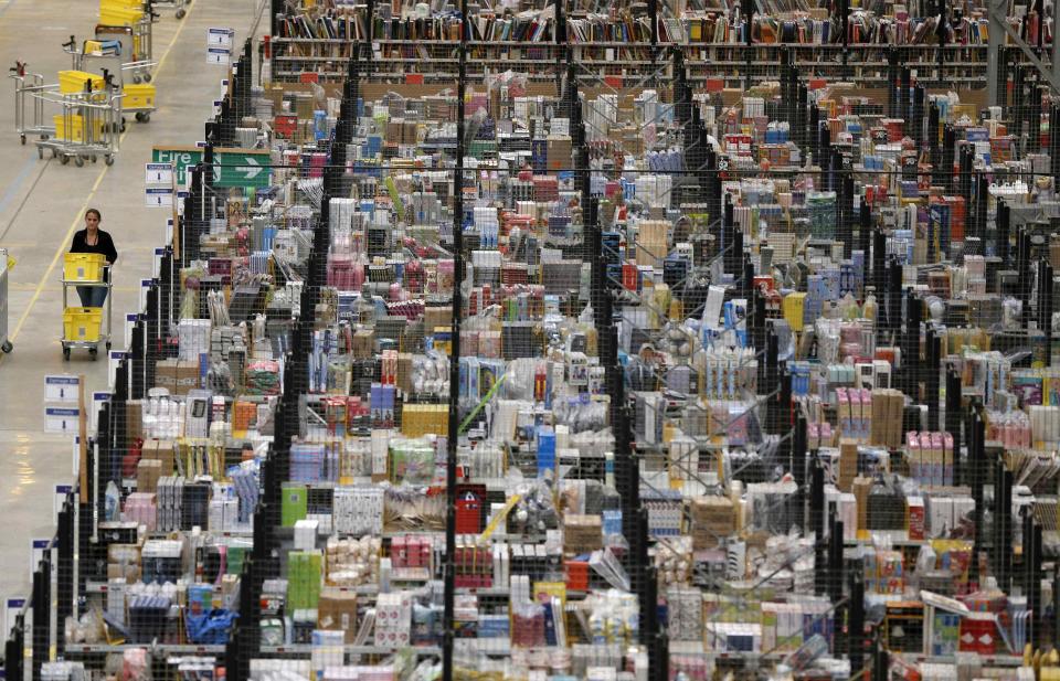 A member of staff pushes a trolley as she collects orders at the Amazon fulfilment centre in Peterborough, central England November 28, 2013. The centre is preparing for Cyber Monday, which is considered the busiest day for online shopping in Britain and will fall on Monday, December 2 this year. REUTERS/Phil Noble