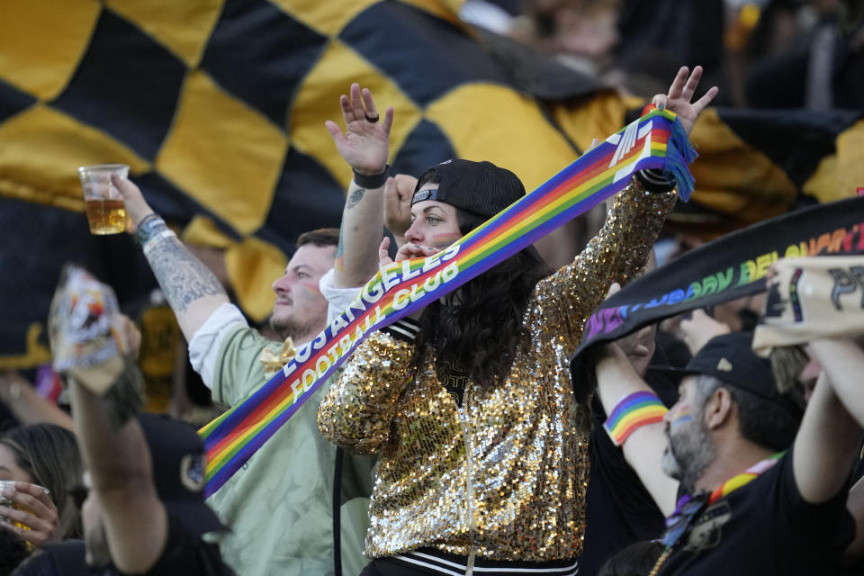 Los Angeles FC fans cheer while holding a Pride scarf before the team's MLS soccer match against the Vancouver Whitecaps in Los Angeles, Saturday, June 24, 2023. (AP Photo/Ashley Landis)