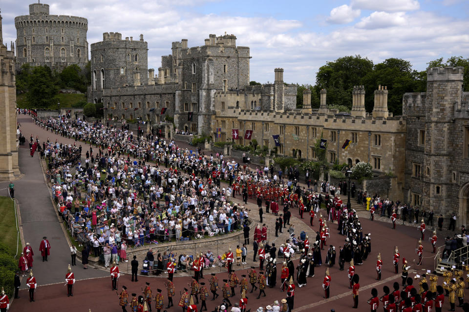 The procession walks to St George's Chapel for the Order of the Garter service at Windsor Castle, in Windsor, England, Monday, June 13, 2022. The Order of the Garter is the oldest and most senior Order of Chivalry in Britain, established by King Edward III nearly 700 years ago. This year Prince Charles' wife Camilla, the Duchess of Cornwall, former British Prime Minister Tony Blair and former leader of the British House of Lords Baroness Amos were all installed in the Order. (AP Photo/Matt Dunham, Pool)