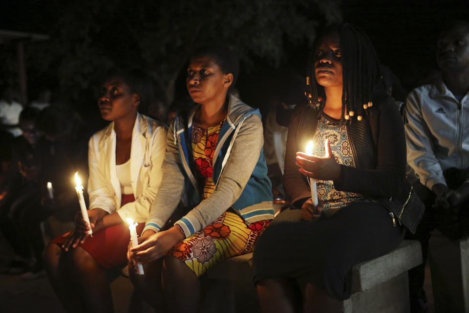 A night vigil prayer is held for a missing doctor, Peter Magombeyi, by well-wishers and fellow doctors at Harare hospital, Tuesday, Sept. 17, 2019. The Zimbabwe Hospitals Association has said that that their president, Peter Magombeyi, was abducted on Saturday, days after receiving threats on his phone. Magombeyi had expressed concerns to journalists about the poor state of Zimbabwe's hospitals.(AP Photo/Tsvangirayi Mukwazhi)