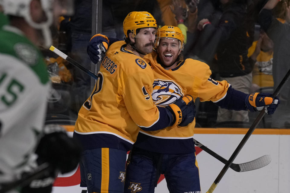 Nashville Predators left wing Filip Forsberg (9) celebrates his goal with center Jonathan Marchessault (81) during the second period of an NHL hockey game against the Dallas Stars, Thursday, Oct. 10, 2024, in Nashville, Tenn. (AP Photo/George Walker IV)