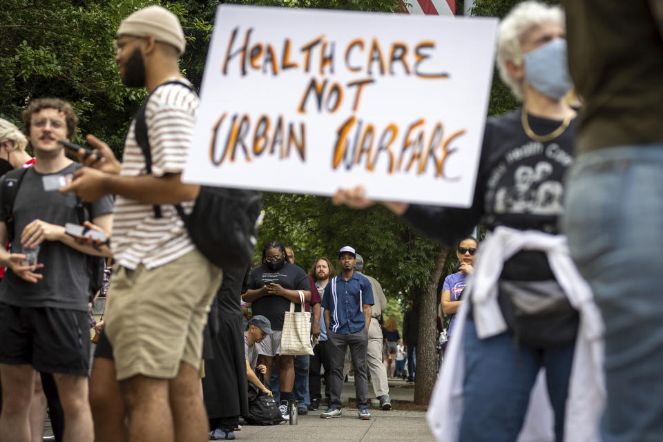 Protesters gather outside Atlanta City Hall ahead of a council vote over whether to approve public funding for the construction of a proposed police and firefighter training center, Monday, June 5, 2023. (Arvin Temkar/Atlanta Journal-Constitution via AP)