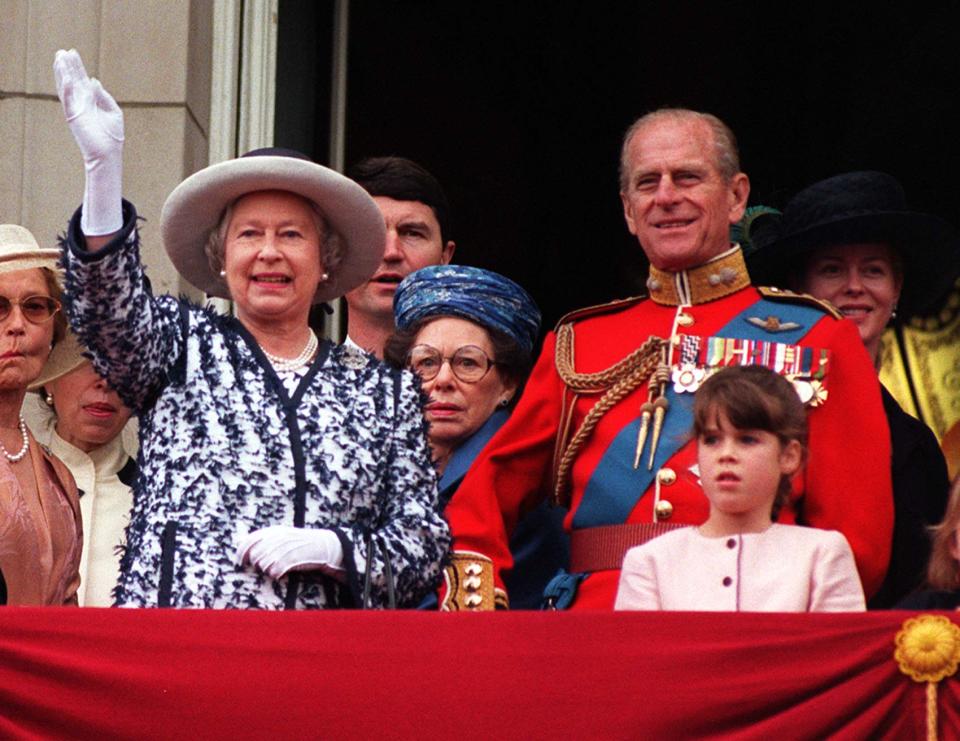 The Queen waves to the crowds as she stands on the balcony of Buckingham Palace with the Duke of Edinburgh and other members of the Royal Family after watching the traditional fly-past as part of the Trooping of the Colour in honour of the Her official birthday today (Saturday). Left to right: The Queen, Tim Laurence (Princess Anne's husband) Princess Margaret (wearing blue hat), The Duke of Edinburgh, Princess Eugenie (pink dress), Lady Helen Taylor (dressed in black), unidentified young girl and The Duke of Kent. See PA story ROYAL Trooping. WPA rota picture by John Stillwell/PA   (Photo by John Stillwell - PA Images/PA Images via Getty Images)