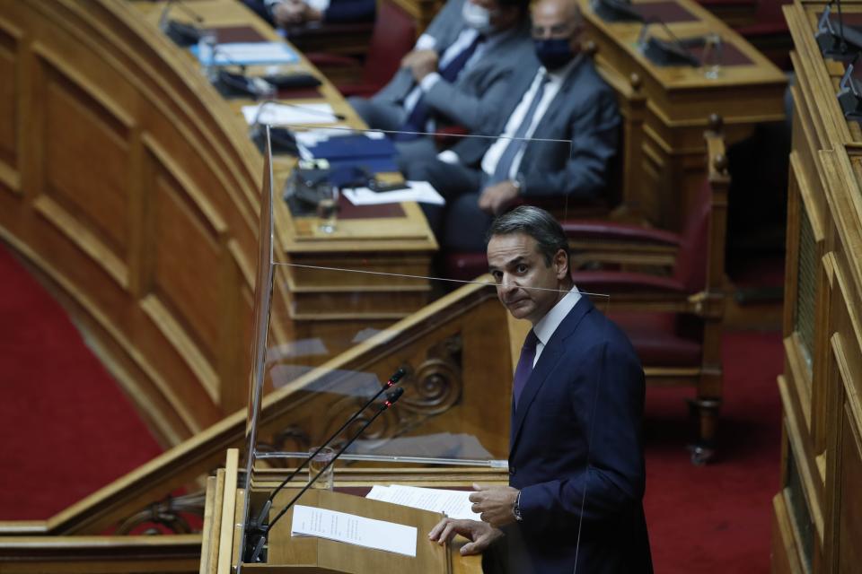 Greece's Prime Minister Kyriakos Mitsotakis speaks during a parliament debate in Athens, Wednesday, Aug. 26, 2020. Mitsotakis says his country is planning to exercise its legal right to extend territorial waters along its western coastline from six to 12 nautical miles. The plan was announced Wednesday as Greece remains locked in an escalating dispute over maritime boundaries with neighbor Turkey, with a survey mission and military exercises currently being held in east Mediterranean waters claimed by both countries. (AP Photo/Thanassis Stavrakis)