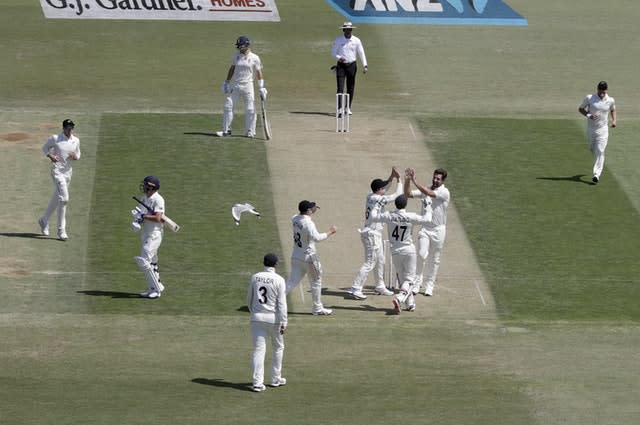 Burns walks from the field as New Zealand players celebrate 