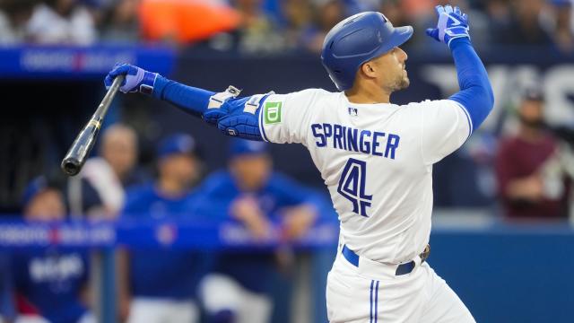 George Springer of the Toronto Blue Jays looks on from the dugout