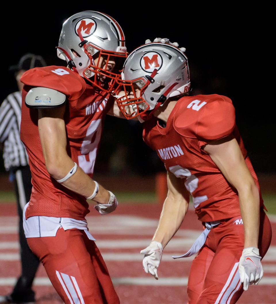 Morton running backs Conner Hines, left, and Carl Whitaker celebrate one of Whitaker's second-half touchdowns against Richwoods on Friday, Sept. 2, 2022 in Morton.