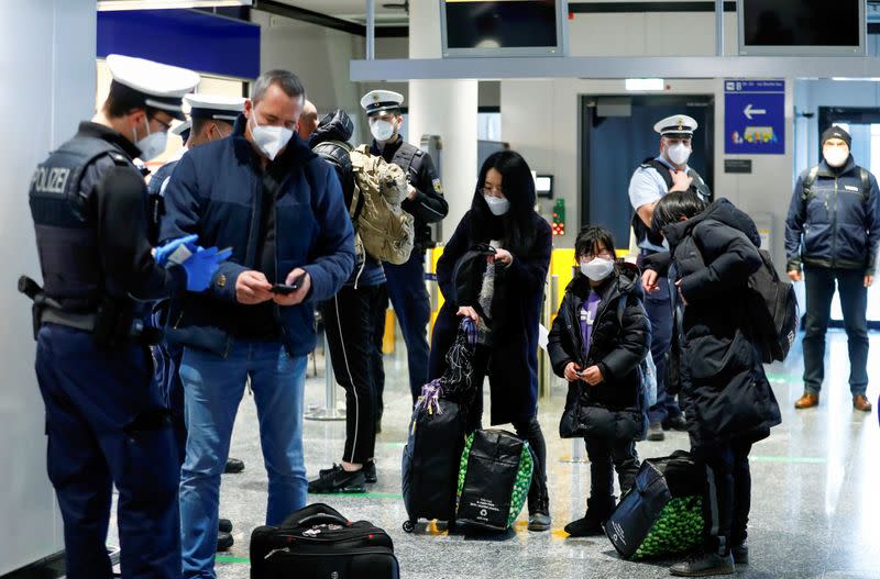 FILE PHOTO: Federal police officers check flight passengers arriving from Britain at Frankfurt Airport