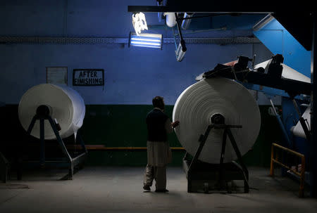 A worker monitors linen being processed at the Kohinoor textile plant in Rawalpindi, Pakistan March 14, 2017. REUTERS/Caren Firouz