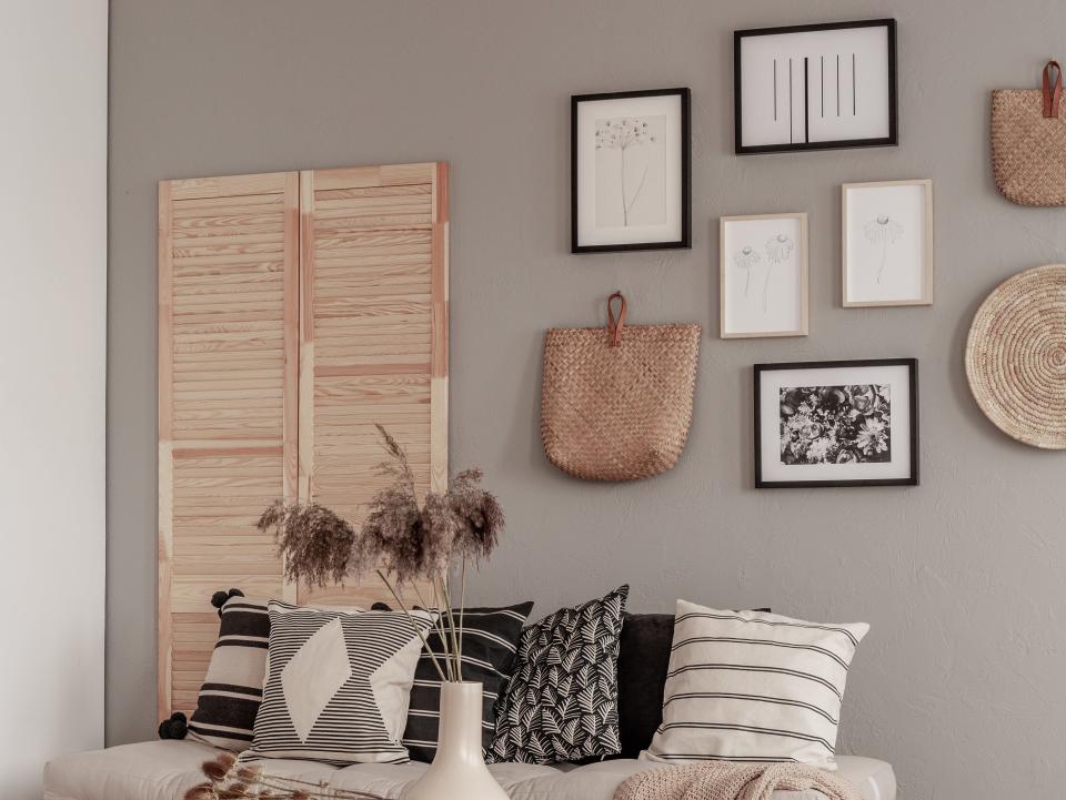 A neutral-toned living room with a gallery wall of art