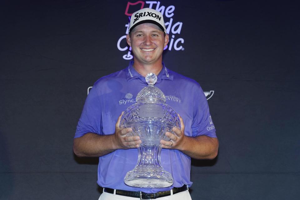 Sepp Straka, of Austria, holds the Honda Classic trophy after winning the final round of the golf tournament, Sunday, Feb. 27, 2022, in Palm Beach Gardens, Fla. (AP Photo/Marta Lavandier)