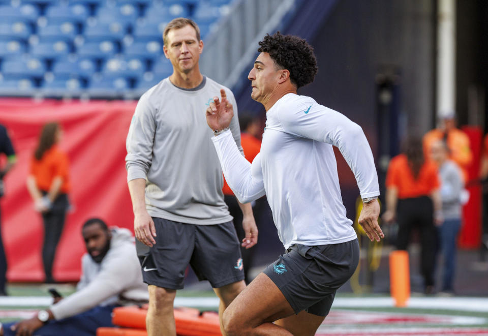 Miami Dolphins outside linebackers coach Ryan Slowik works with Dolphins linebacker Jaelan Phillips (15) before the start of an NFL football game against New England Patriots at Gillette Stadium on Sunday, Sept. 17, 2023 in Foxborough, Ma. (David Santiago/Miami Herald via AP)