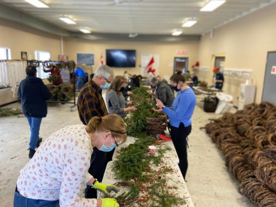 Volunteers from the community came together on Saturday, Dec. 4, 2021 to assemble and decorate more wreaths after thousands were stolen from a rural property in Maxville, Ont., approximately 75 kilometres southeast of downtown Ottawa last weekend. The wreaths were meant to be laid at the tombstones of Canadian Armed Forces members at the National Military Cemetery. (Celeste Decaire/CBC - image credit)