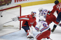 New York Rangers left wing Alexis Lafrenière (13) scores a goal past Washington Capitals goaltender Vitek Vanecek (41) during the second period of an NHL hockey game, Saturday, Feb. 20, 2021, in Washington. Also seen are Capitals defenseman John Carlson (74) and Rangers center Mika Zibanejad (93). (AP Photo/Nick Wass)