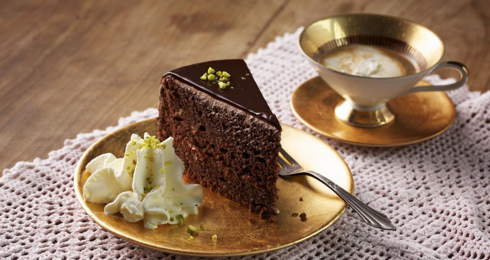 Cake and coffee in gold plates and cup