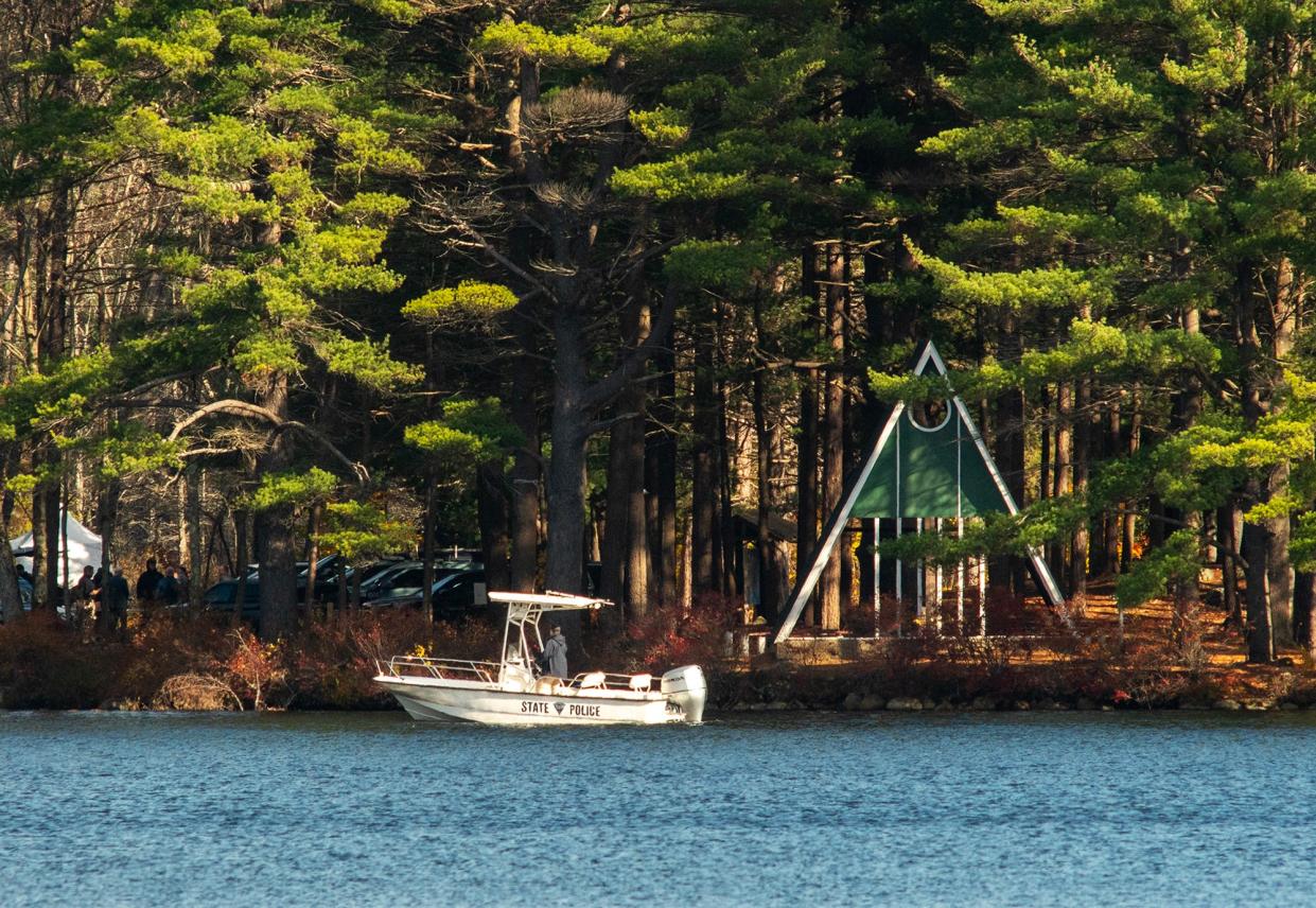 A state police boat passes the camp chapel on the shore of Camp Collier as the search for Aaron Pennington continues Friday.