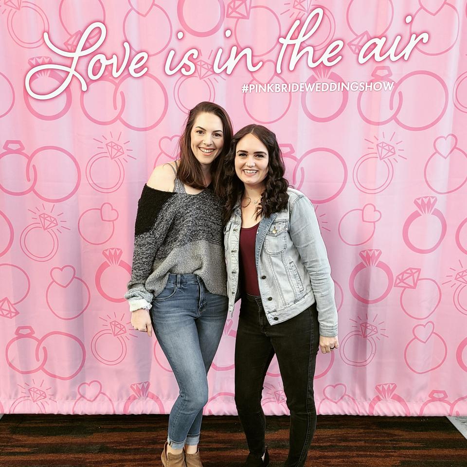 Wedding planners Tiffany Brown (left) and Laura Shadler have fun while working at shows to land clients for their business, Simply Tennessee Weddings.