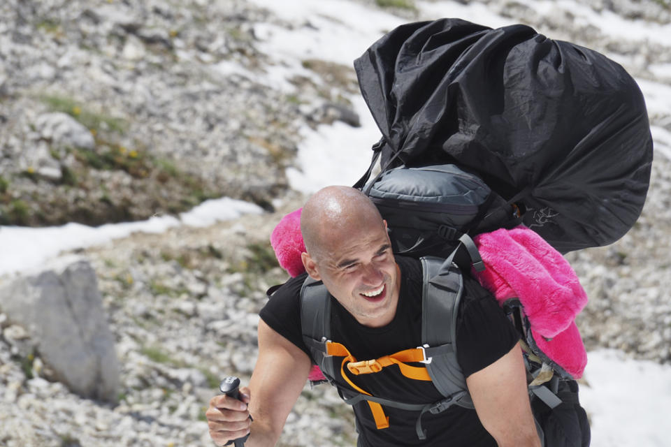 Paul climbing up the Dolomites carrying his pink bear suit (Collect/PA Real Life)