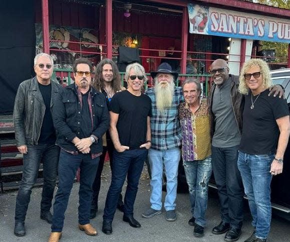 Bon Jovi members Hugh McDonald (left to right), John Shanks, Phil Xenidis, Jon Bon Jovi, a beaded friend, Tico Torres, Everett Bradley and David Bryan outside Sant's Pub in Nashville in a Nov. 14, 2023, social media post.