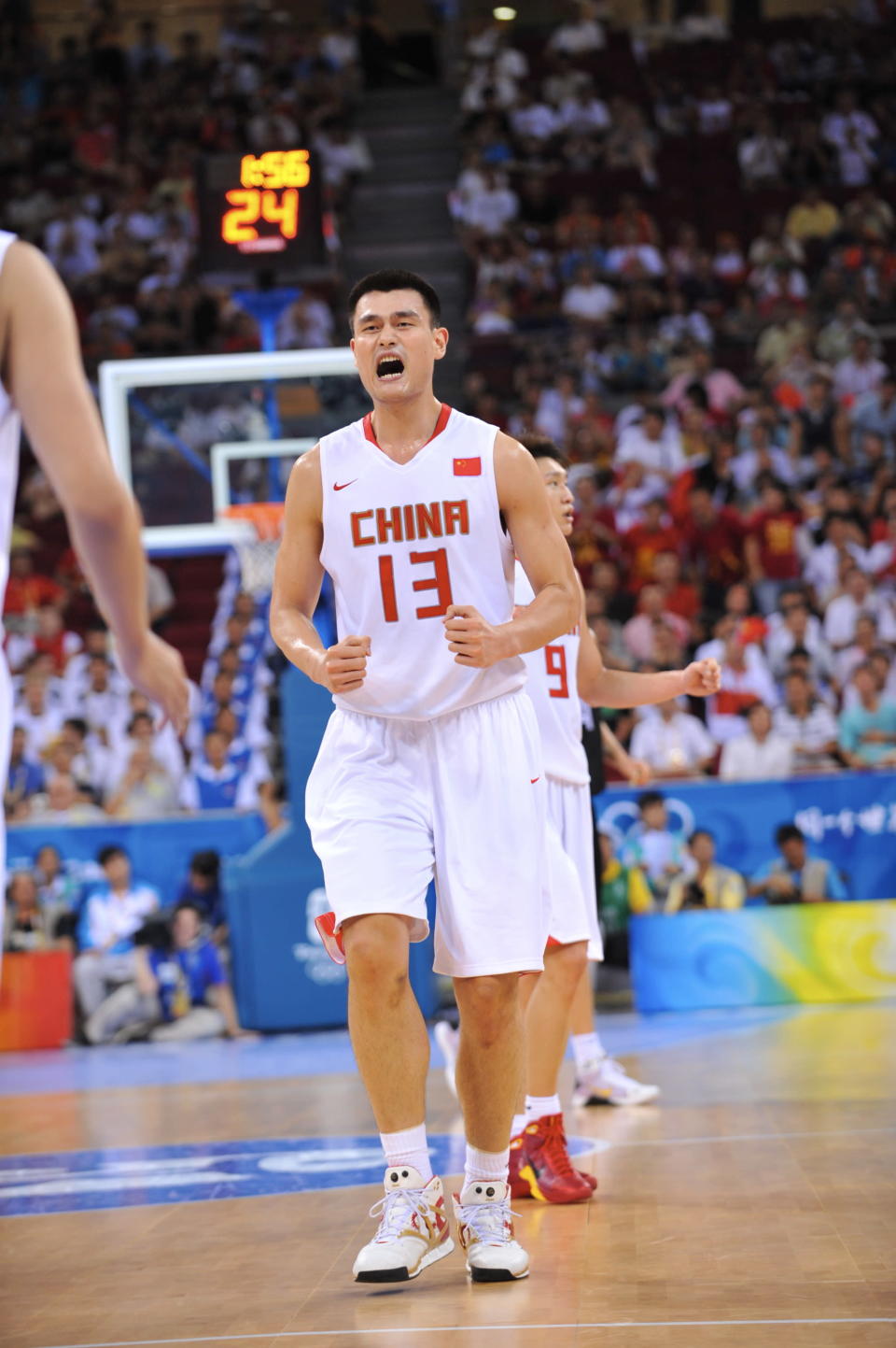 BEIJING - AUGUST 16: Yao Ming #13 of China celebrates against Germany during the group B preliminary basketball game at the Beijing Olympic Basketball Gymnasium on Day 8 of the Beijing 2008 Olympic Games on August 16, 2008 in Beijing, China. China won 59-55 NOTE TO USER: User expressly acknowledges and agrees that, by downloading and/or using this Photograph, user is consenting to the terms and conditions of the Getty Images License Agreement. Mandatory Copyright Notice: Copyright 2008 NBAE (Photo by Jesse D. Garrabrant/NBAE via Getty Images)