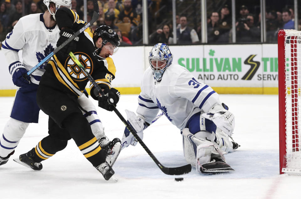 FILE - In this April 23, 2019, file photo, Boston Bruins left wing Brad Marchand, left, tries unsuccessfully to shoot past Toronto Maple Leafs goaltender Frederik Andersen (31) during the second period of Game 7 of an NHL hockey first-round playoff series, in Boston. With Tampa Bay, Boston, the Toronto Maple Leafs and refueled Florida Panthers, the Atlantic Division looks like murderer’s row. The Bruins got through only after coming back from a 3-2 first-round deficit against Toronto and aren’t feeling overly cocky because the same rocky road remains. (AP Photo/Charles Krupa, File)