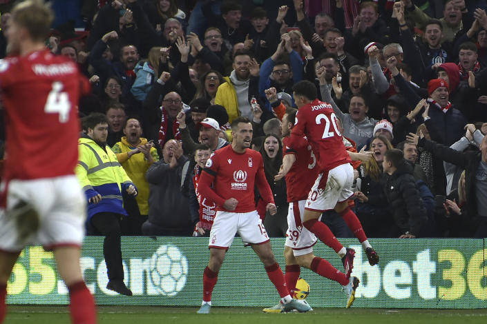 Nottingham Forest players celebrate after Nottingham Forest's Chris Wood scored his side's opening goal during the English Premier League soccer match between Nottingham Forest and Manchester City at City ground in Nottingham, England, Saturday, Feb. 18, 2023. (AP Photo/Rui Vieira)