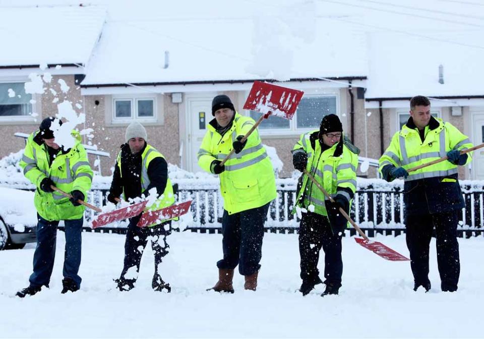 North Lanarkshire Council Workers clearing snow from Lorne Gardens Sheltered Housing in Scotland after 6 inches of snow fell on Sunday night and Monday.