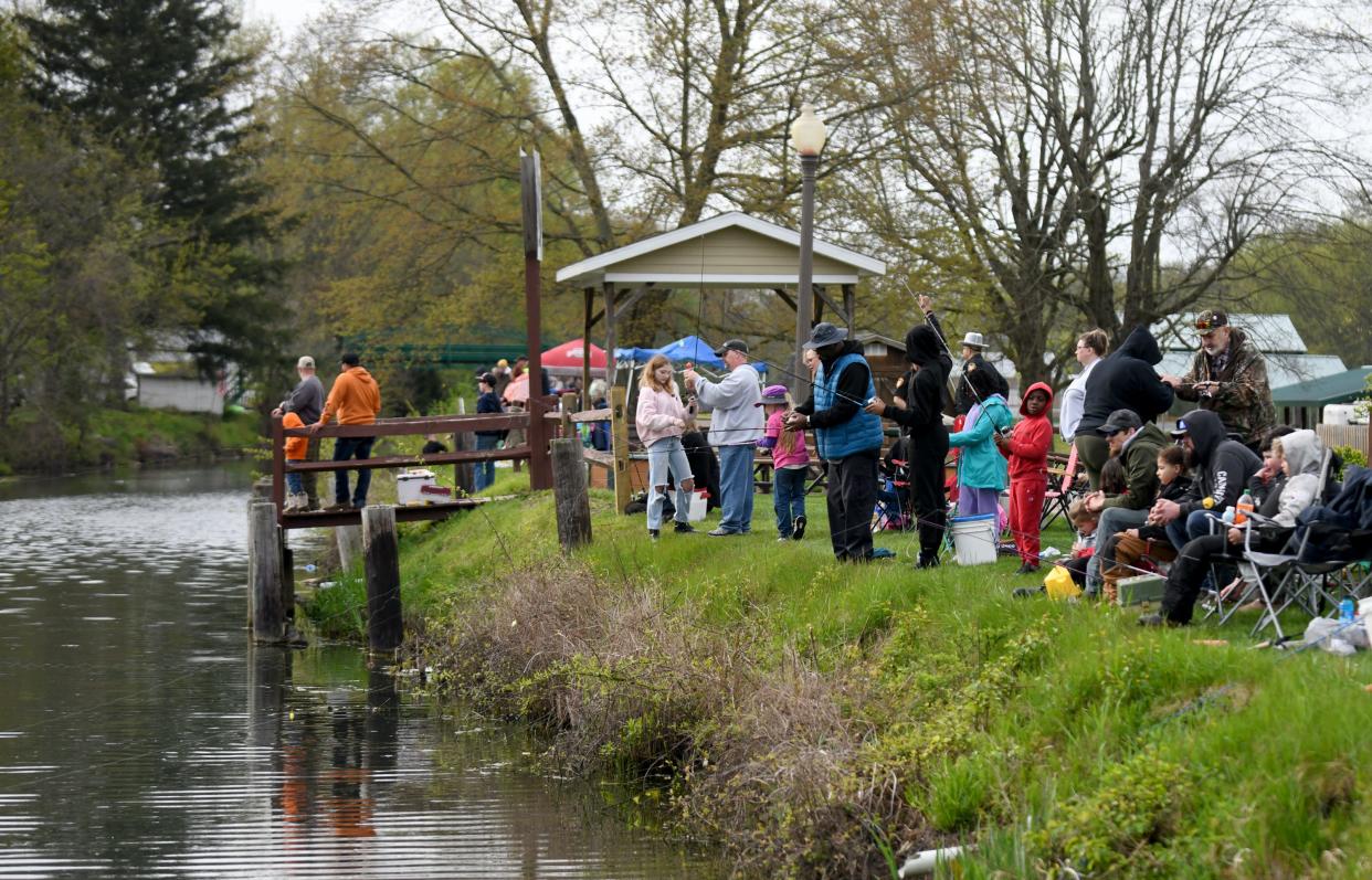 A crowd gathers along the shore of the in St. Helena Heritage Park in Canal Fulton for The Jack Cullen Towpath Trail Trout Derby.