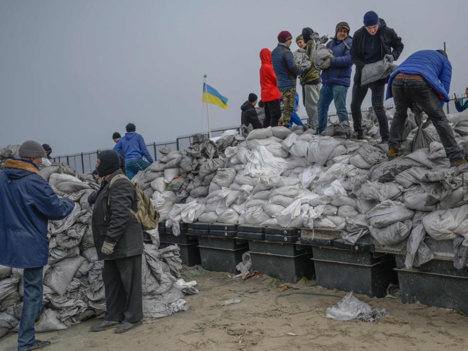 Citizens fill bags with sand for frontlines along the beach of the Black Sea city of Odessa, in southern Ukraine, on 7 March 2022 (AFP via Getty Images)