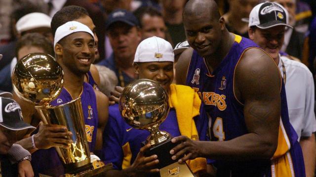 Los Angeles Lakers Kobe Bryant, left, holding the championship trophy,  celebrates with teammates Rick Fox, Lindsey Hunter, second from right, and  Shaquille O'Neal, right, holding the MVP trophy, after winning Game 4